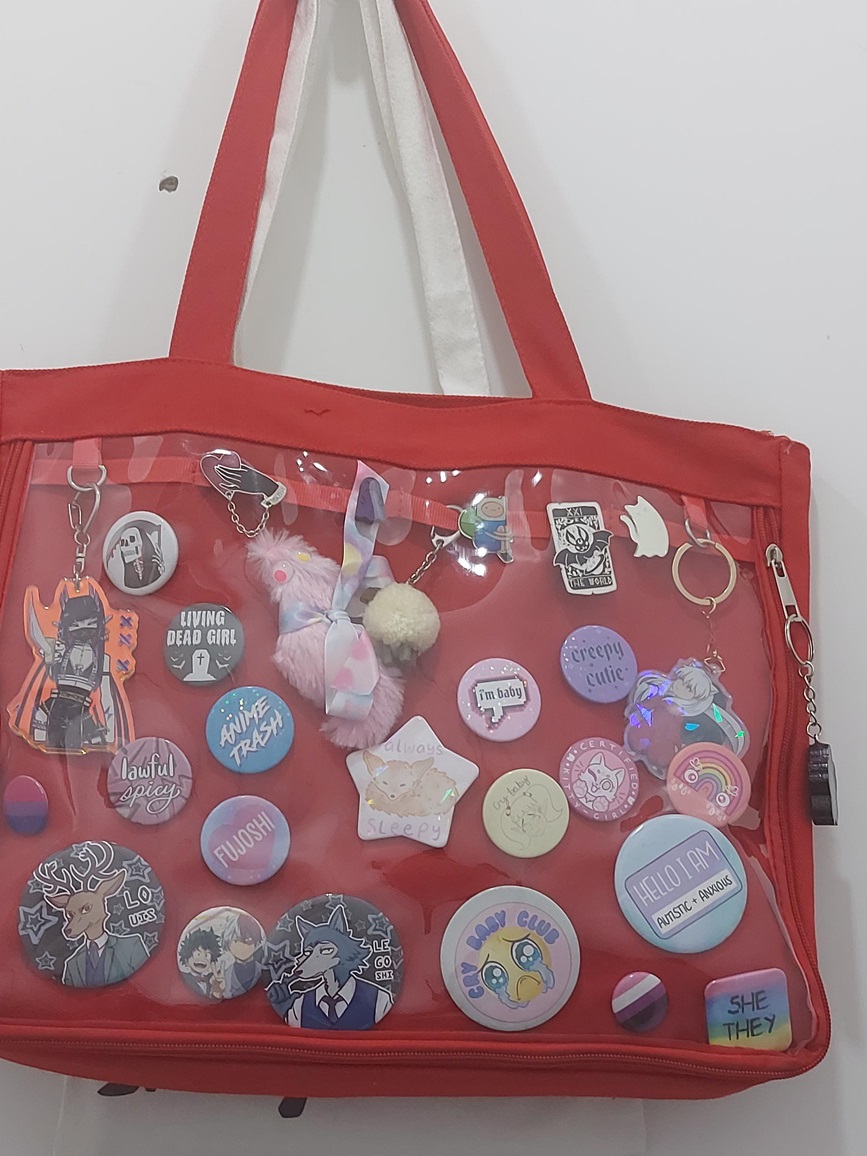 a red bag full of pin badges