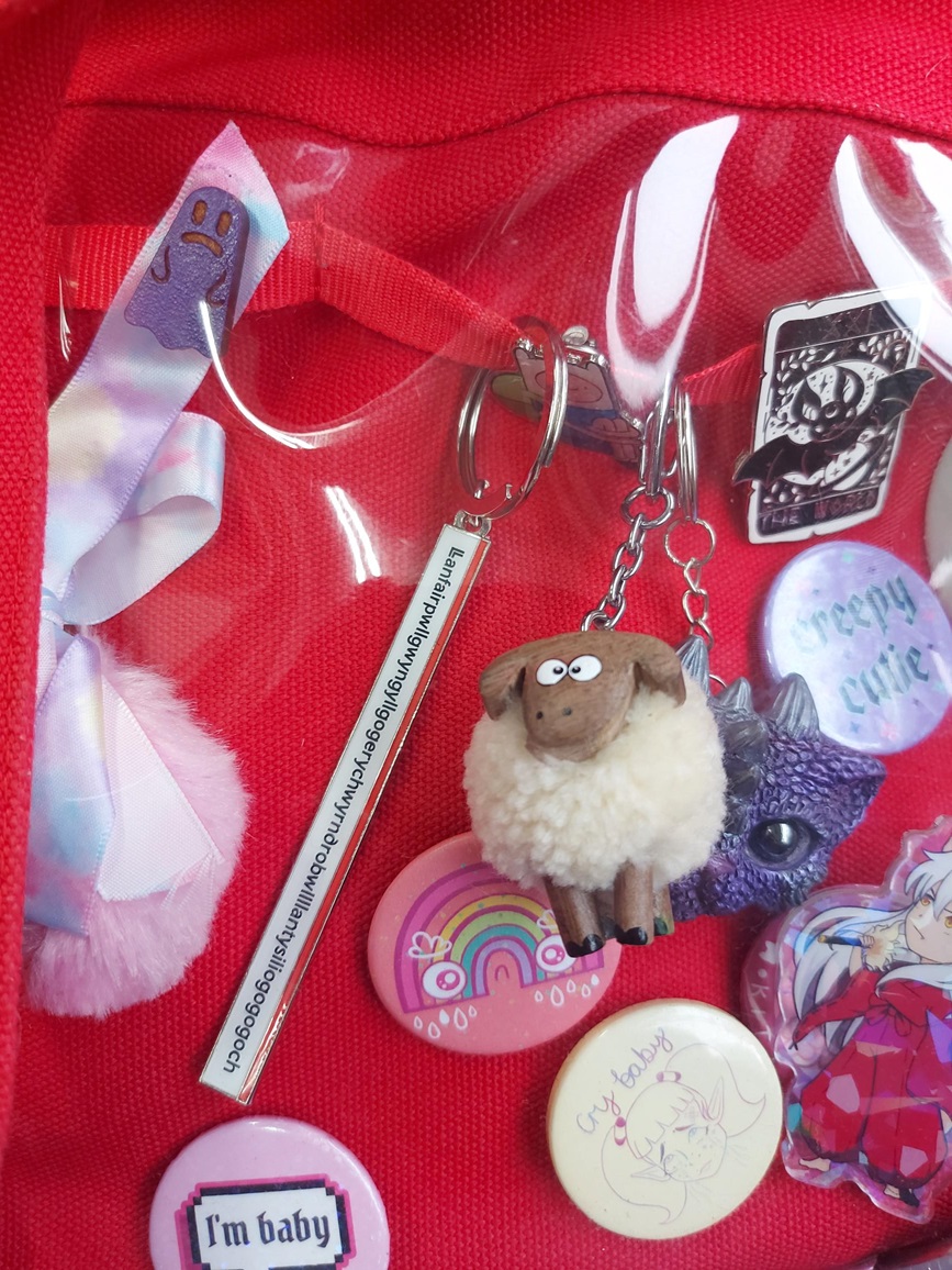 a close up of the red bag showing off two keyrings